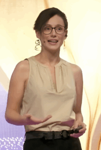 Chilean journalist Macarena Rojas Abalos talks to an audience on a stage.