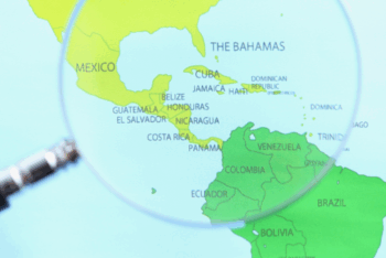 Magnifying glass over map of Latin America and the Caribbean