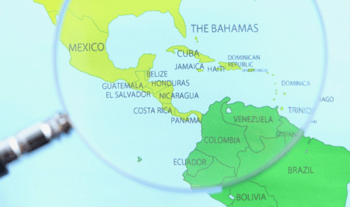 Magnifying glass over map of Latin America and the Caribbean