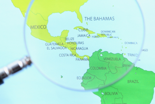 Magnifying glass over map of Latin America and the Caribbean