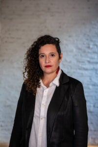 Woman in suit jacket and white blouse