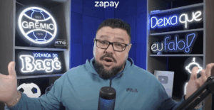 Person in glasses in front of microphone on sports show
