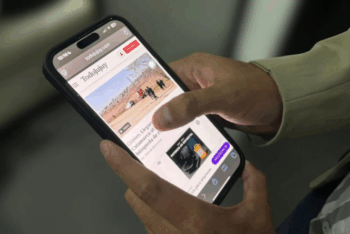 Person scrolling through a news article on their mobile phone