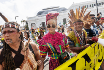 Three people holding a banner in a march