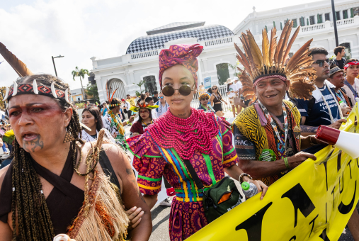 Three people holding a banner in a march