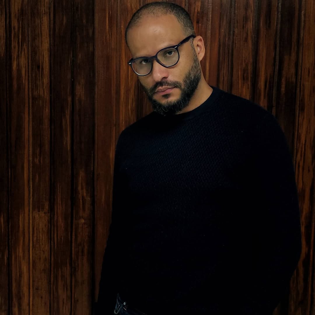 Man in a black sweater looking at the camera