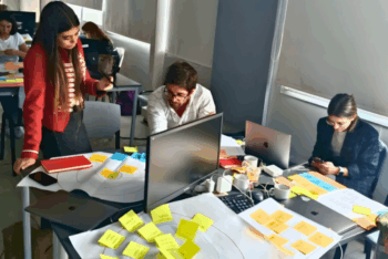 Journalists work during an AI prototyping train
