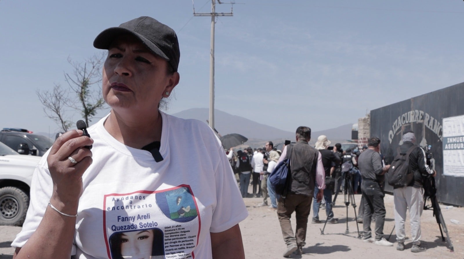 Patricia Sotelo, the mother of a missing person, gives an interview to the media outside a suspected forced recruitment center run by a drug cartel in Jalisco, Mexico. (Photo: 